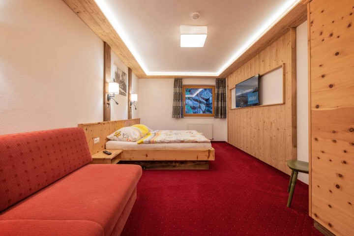 Cozy room with a bed and a couch, ideal for relaxing and unwinding.