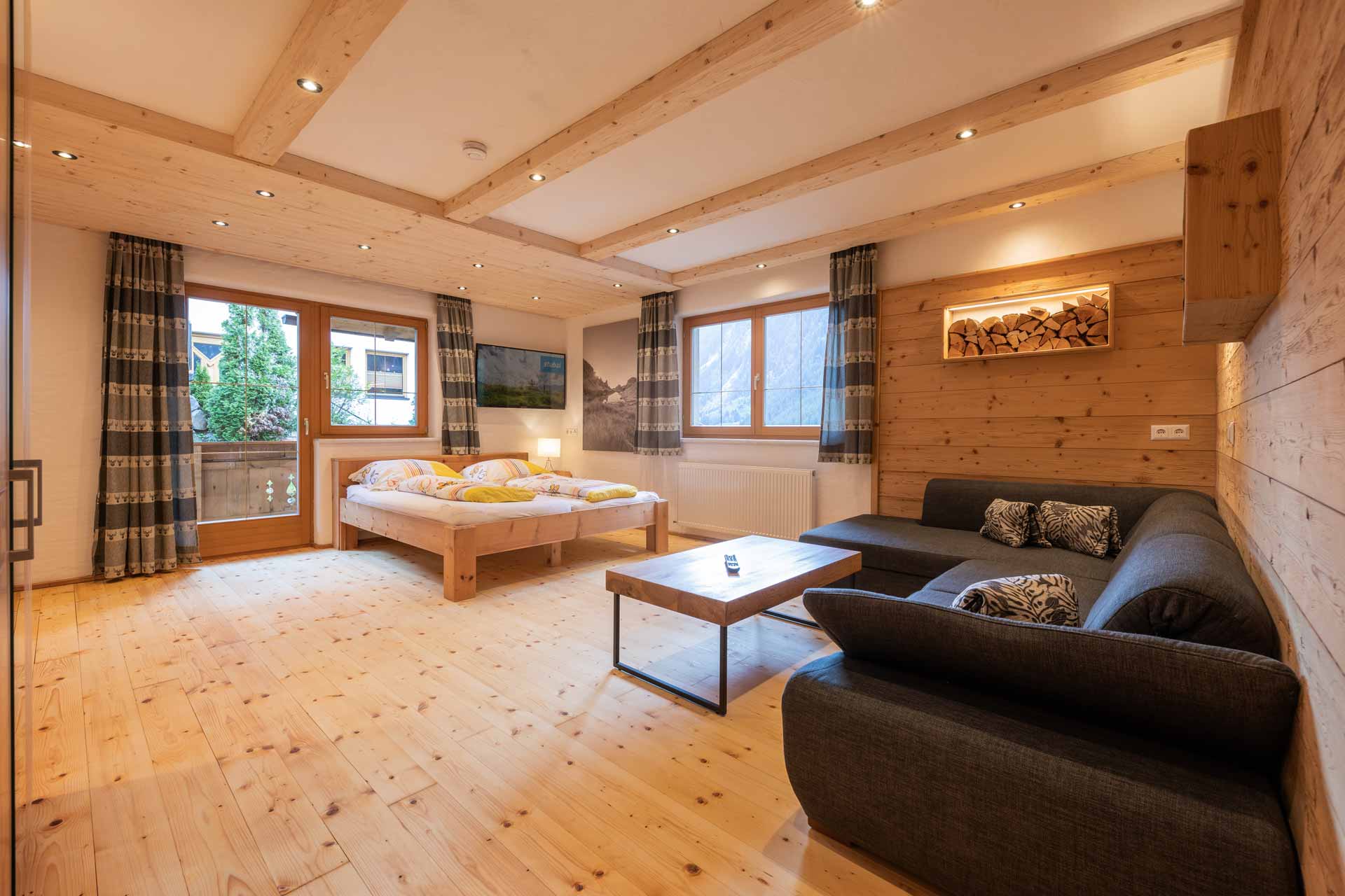 Apartment Morgentau: A room with warm wooden walls and an inviting bed for restful nights. Accommodation in the Stubai Valley, Tyrol.