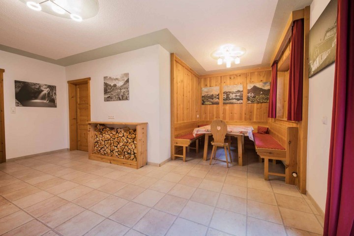 A cozy room, furnished with a table and several chairs.