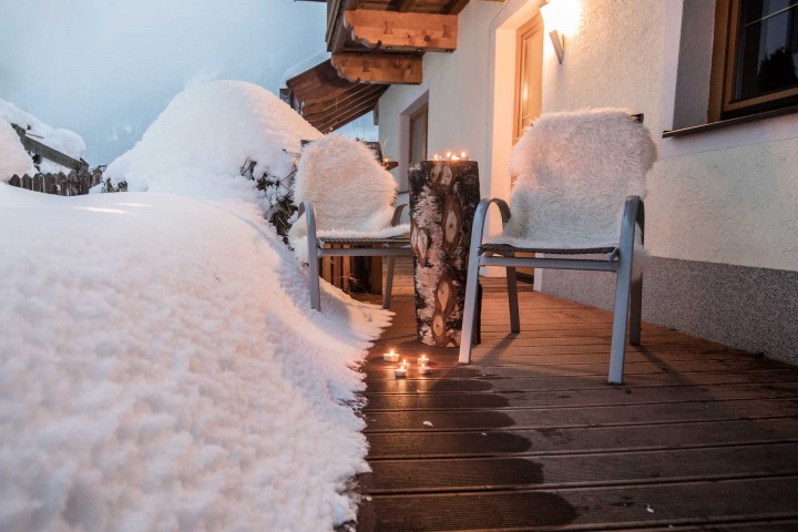 Terrace covered with snow with cozy seating