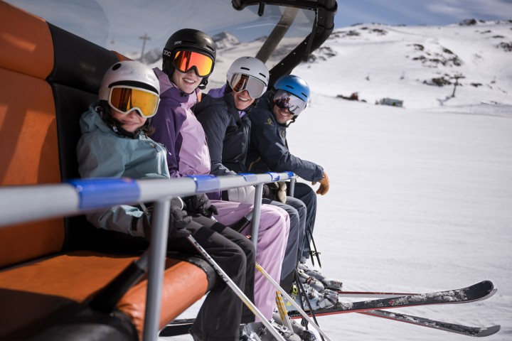 Ski lift in the Stubai Valley, Tyrol: Family looking happily into the camera