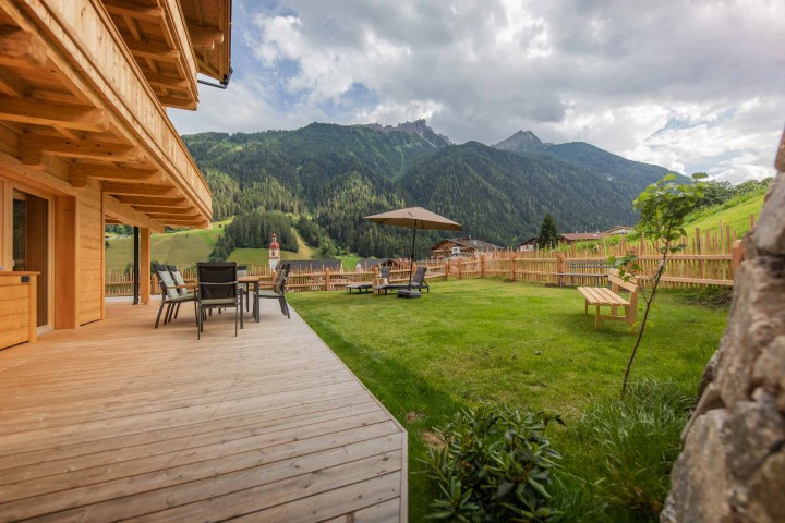 Large terrace with seating on the terrace and in the green grass. Wonderful view of the mountains and surrounded by nature
