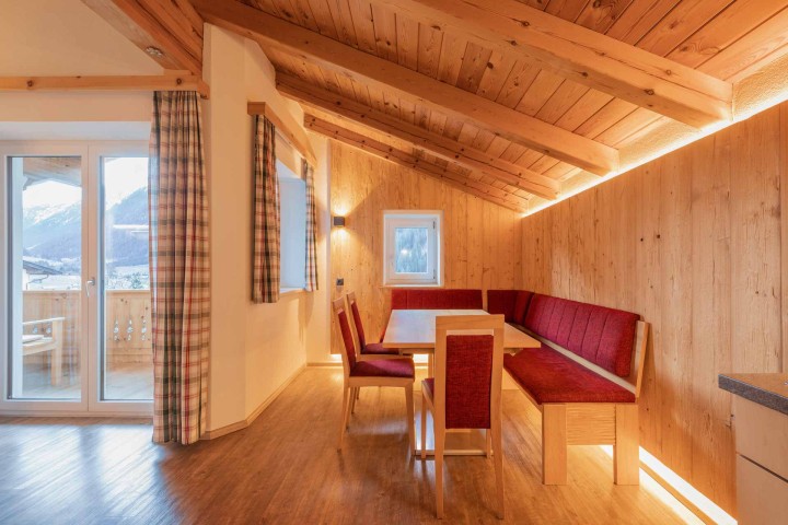 Gemütliche Eckbank mit Tisch und Stühlen und Ausblick in die Natur